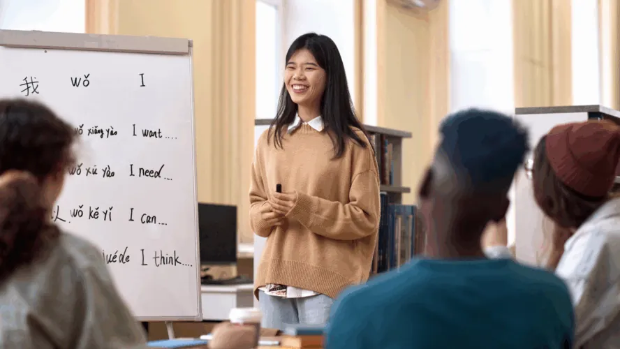Students learn Chinese by writing characters on the board.